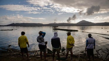 A group of fishermen make repairs to their operations affected by the ash-fall from the Taal volcano, January 20, 2020. (AFP)