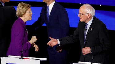 Democratic presidential candidate Sen. Elizabeth Warren and Sen. Bernie Sanders talk after a Democratic presidential primary debate hosted by CNN and the Des Moines Register. (AP)