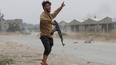 FILE PHOTO: A fighter loyal to Libya's U.N.-backed government (GNA) gestures during a clash with forces loyal to Khalifa Haftar at the outskirts of Tripoli, Libya May 21, 2019. REUTERS/Goran Tomasevic - RC11064E61F0/File Photo