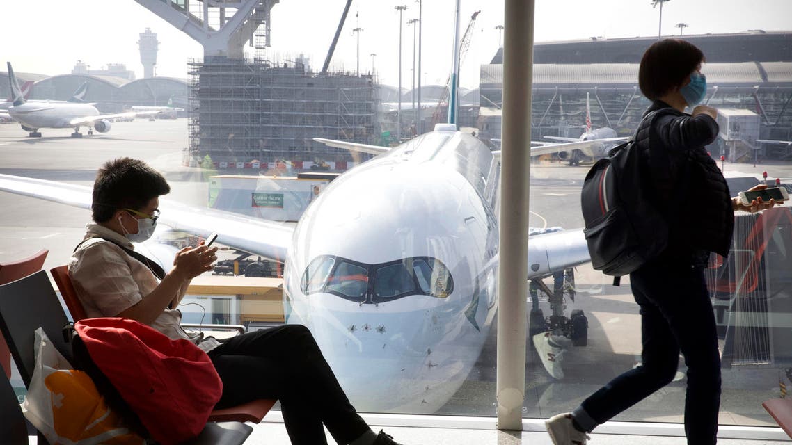 Travelers wear face masks as they wait their flight at Hong Kong International Airport in Hong Kong, Tuesday, Jan. 21, 2020. (AP)