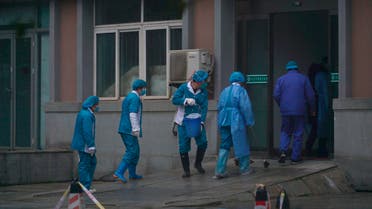 Hospital staff wash the emergency entrance of Wuhan Medical Treatment Center, where some infected with a new virus are being treated, in Wuhan, China, Wednesday, Jan. 22, 2020. (AP)