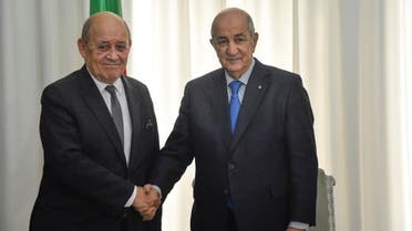 Algerian President Abdelmadjid Tebboune (R) meets with the visiting French Foreign Minister Jean-Yves Le Drian in the capital Algiers on January 21, 2020. (AFP)