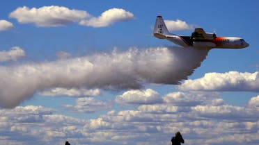 Photographers take photographs of the Large Air Tanker (LAT) C-130 Hercules, also known as ‘Thor’, as it drops a load of around 15,000 liters during a display by the Rural Fire Service ahead of the bushfire season at RAAF Base Richmond Sydney, Australia, September 1, 2017. (File photo: Reuters)