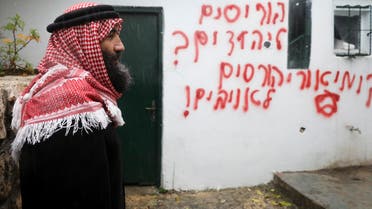 Palestinians visit vandalized mosque in the Arab neighborhood of Beit Safafa, in east Jerusalem on Jan. 24, 2020. (AP)