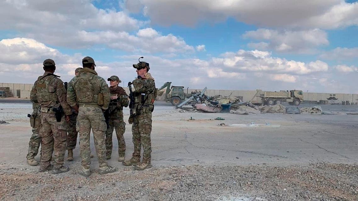 U.S. Soldiers stand while bulldozers clear rubble and debris at Ain al-Assad air base in Anbar, Iraq, Monday, Jan. 13, 2020. (AP)