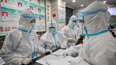 Medical staff members wearing protective clothing to help stop the spread of a deadly virus which began in the city, work at the Wuhan Red Cross Hospital in Wuhan on January 25, 2020. (AFP)
