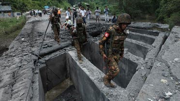 Soldiers walk over Gote Twin bridge damaged by explosion Thursday, Aug. 15, 2019, in Gote Twin, Naung Cho township, northern Shan State, Myanmar.  (AFP)