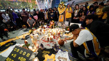 Mourners gather in Microsoft Square near the Staples Center to pay respects to Kobe Bryant after a helicopter crash killed the retired basketball star, in Los Angeles. (Reuters)
