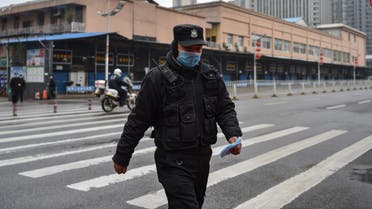 A security guard stands outside the Huanan Seafood Wholesale Market where the coronavirus was detected in Wuhan on January 24, 2020. The death toll in China's viral outbreak has risen to 25, with the number of confirmed cases also leaping to 830, the national health commission said.