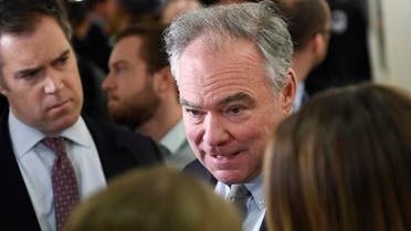 Democrat Senator Tim Kaine (center), talks to reporters on Capitol Hill in Washington, on January 24, 2020, as he heads to a closed, all-senators briefing on the coronavirus. (AP)
