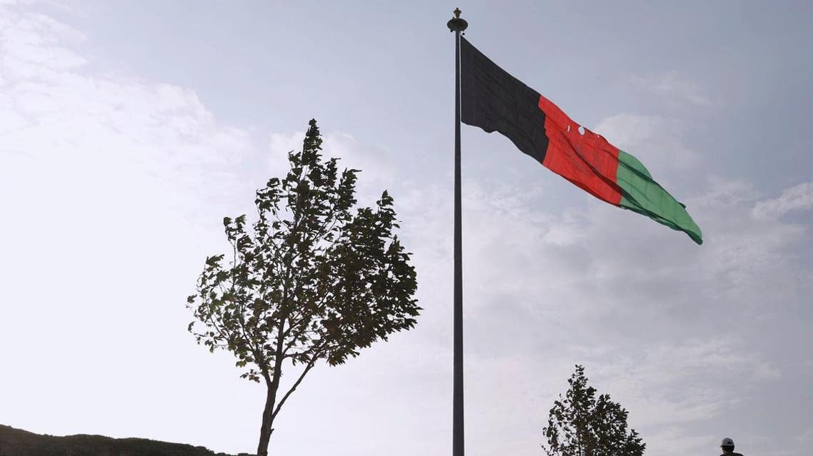 A man walks under Afghanistan's national flag in the early morning in Kabul, Afghanistan September 2, 2019. (File photo: Reuters)