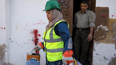 Jordanian woman Saada Turkmani picks up trash from a home as part of a women-run program to improve Jordan's solid waste management, in Shouneh, Jordan, January 15, 2020. (Photo: Reuters)