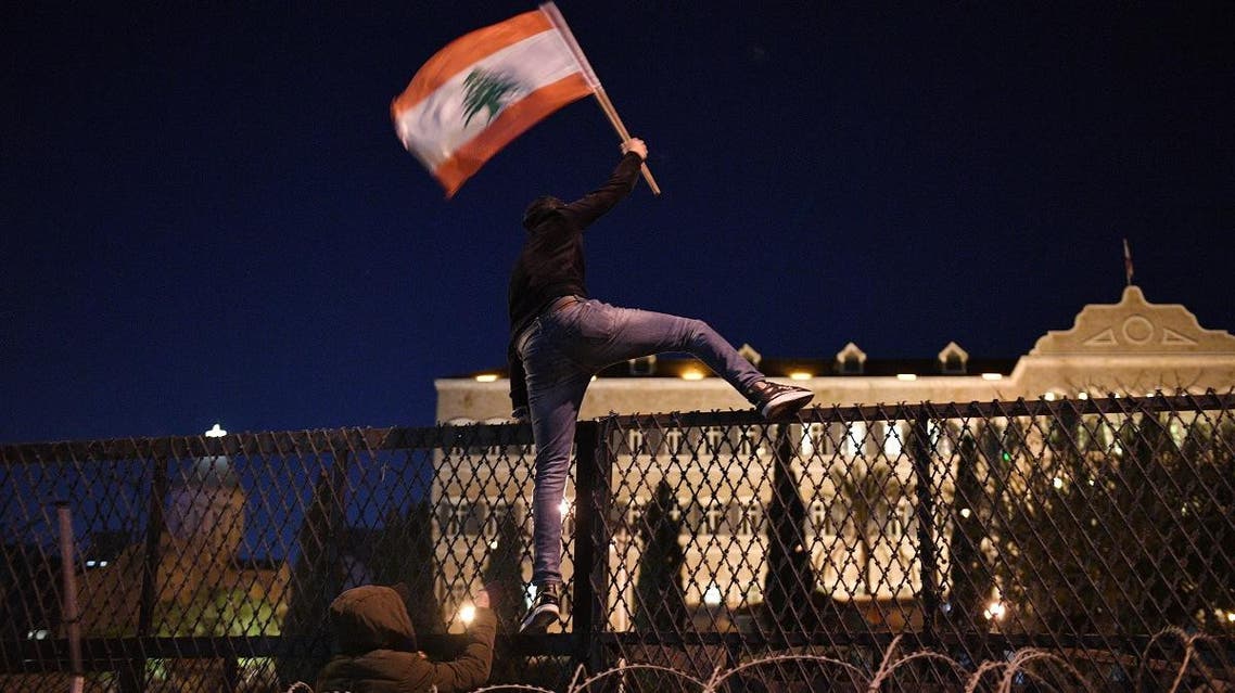 Protesters attack barriers in front of the Grand Serail, the prime minister's headquarters, in Beirut, Lebanon. (Greg Demarque)