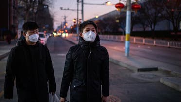 Young men, wearing protective face masks to help stop the spread of a deadly virus which began in Wuhan, as they walk on a street in Beijing on January 29, 2020. (AFP)