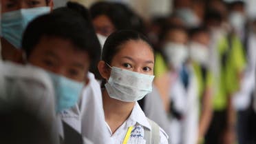 Students line up to sanitize their hands to avoid the contact of coronavirus before their morning class at a hight school in Phnom Penh, Cambodia. (Photo: AP)