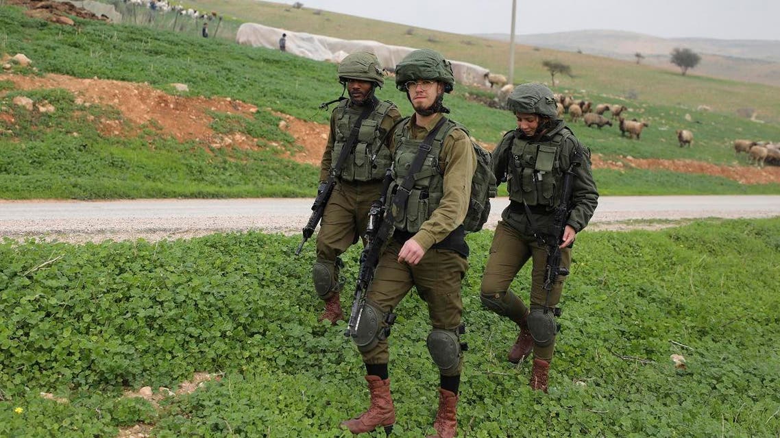 Israeli soldiers patrol past a field near al-Hamra checkpoint in the Jordan Valley in the occupied West Bank. (AFP)
