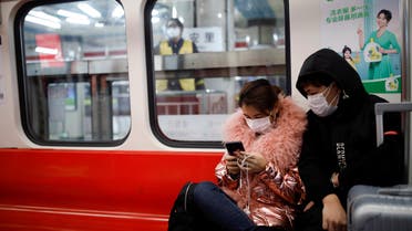 FILE PHOTO: People wearing masks travel in the subway, as the country is hit by an outbreak of the new coronavirus, in Beijing, China January 28, 2020. REUTERS/Carlos Garcia Rawlins/File Photo