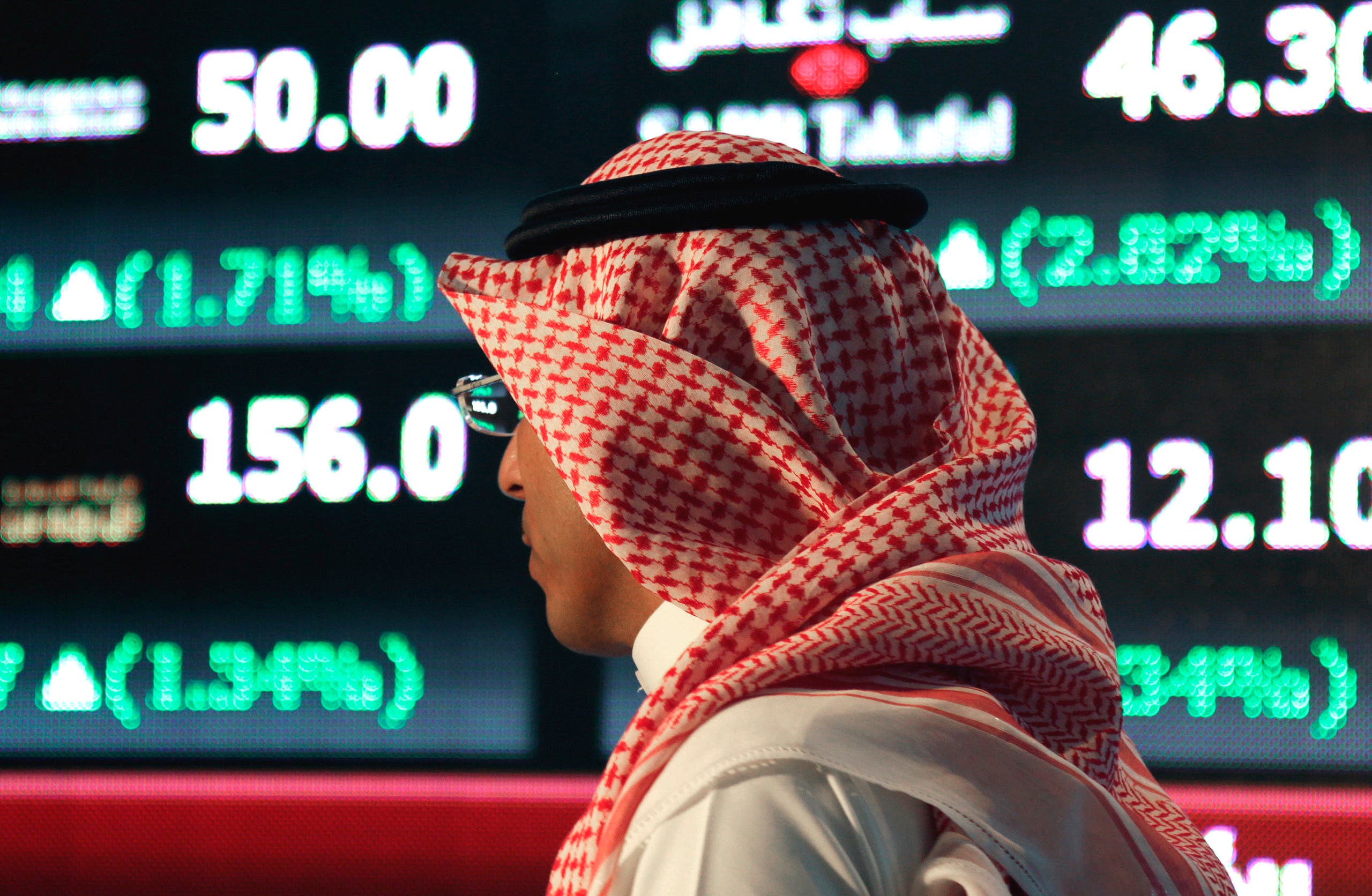 A Saudi man walks at the Tadawul Saudi Stock Exchange, in Riyadh, Saudi Arabia. (File photo: AP)