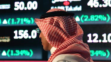 Monday, June 15, 2015 file photo, a Saudi man walks at the Tadawul Saudi Stock Exchange, in Riyadh, Saudi Arabia. King Salman announced the approval for the Vision 2030 plan in a short televised announcement on Monday in which he called on Saudis to work together ensure its success. (AP Photo/Hasan Jamali, File)
