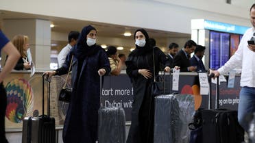 Travellers wear masks as they arrive at the Dubai International Airport, after the UAE's Ministry of Health and Community Prevention confirmed the country's first case of coronavirus, in Dubai, United Arab Emirates. (AP)