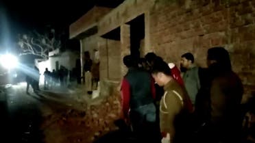 Residents and police personnel stand outside the building where a man has held hostages in Farrukhabad, Uttar Pradesh, India January 30, 2020 0 in this still image taken from video. ANI via REUTERS TV