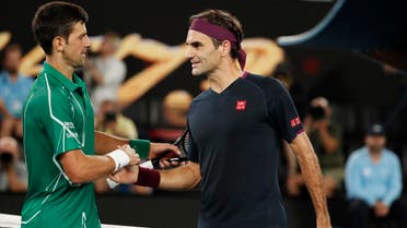 Serbia’s Novak Djokovic and Switzerland’s Roger Federer shake hands after their Australian Open match on January 30, 2019, in Melbourne. (Reuters)
