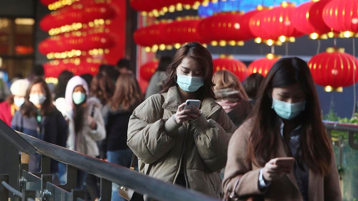 People wear face masks and walk at a shopping mall in Taipei, Taiwan, Friday, Jan. 31, 2020. (AP)