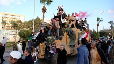 Supporters of Libyan National Army (LNA) commanded by Khalifa Haftar, celebrate on top of a Turkish military armored vehicle, which LNA said they confiscated during Tripoli clashes, in Benghazi, Libya January 28, 2020. (Reuters)