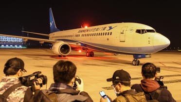 journalists waiting as a plane of Xiamen Airlines carrying Hubei residents arrives from the Thai capital Bangkok (AFP)