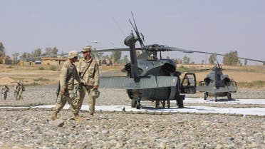 US troops from the 101st Airborne Division walk past Blackhawks at an airbase in Qayyara, 35 kms south of Mosul, in nothern Iraq on their way for lunch break at the base's cafeteria 04 October 2003. The United States has about 130,000 troops in Iraq, almost all from the US Army, the service that has been most stressed by the demands of occupying Iraq while keeping sufficient forces ready for other contingencies, according to a spokesman for the US Central Command at its headquarters in Tampa, Florida. AFP PHOTO/Ahmad AL-RUBAYE