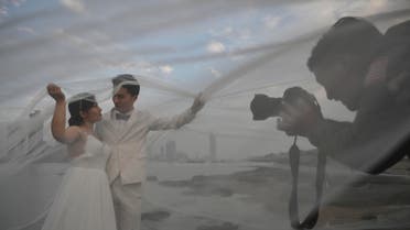 A couple poses for a wedding photographer in Gulangyu Island in Xiamen of Fujian province. (AFP)