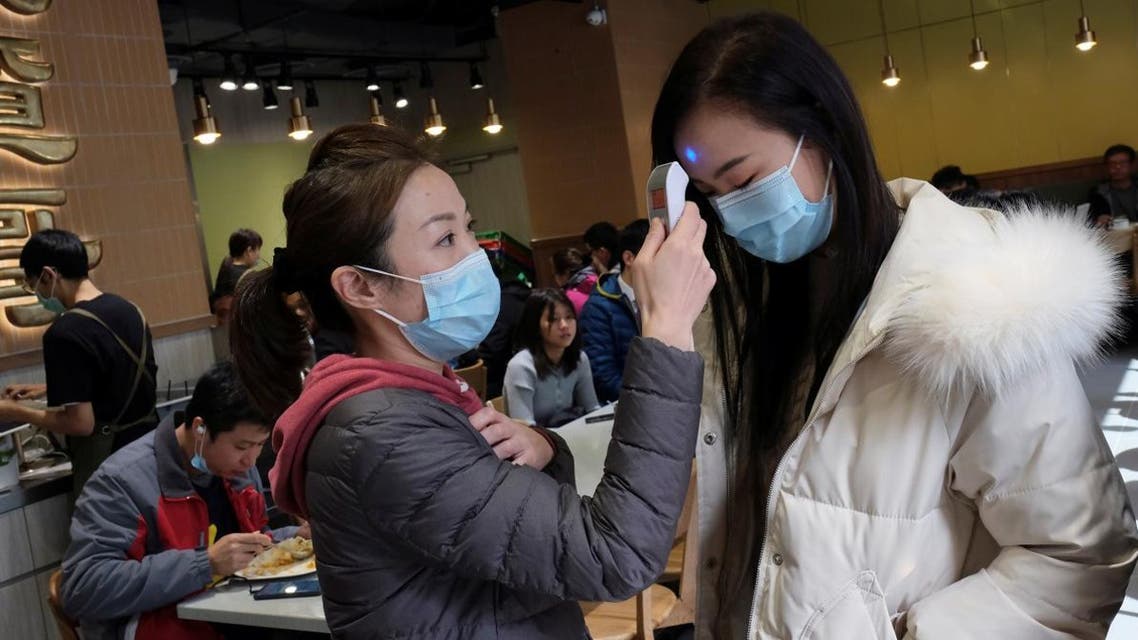 An employee uses a thermometer to check the temperature of a customer at a restaurant, following the outbreak of a new coronavirus, in Hong Kong, China February 1, 2020. (Photo: Reuters)
