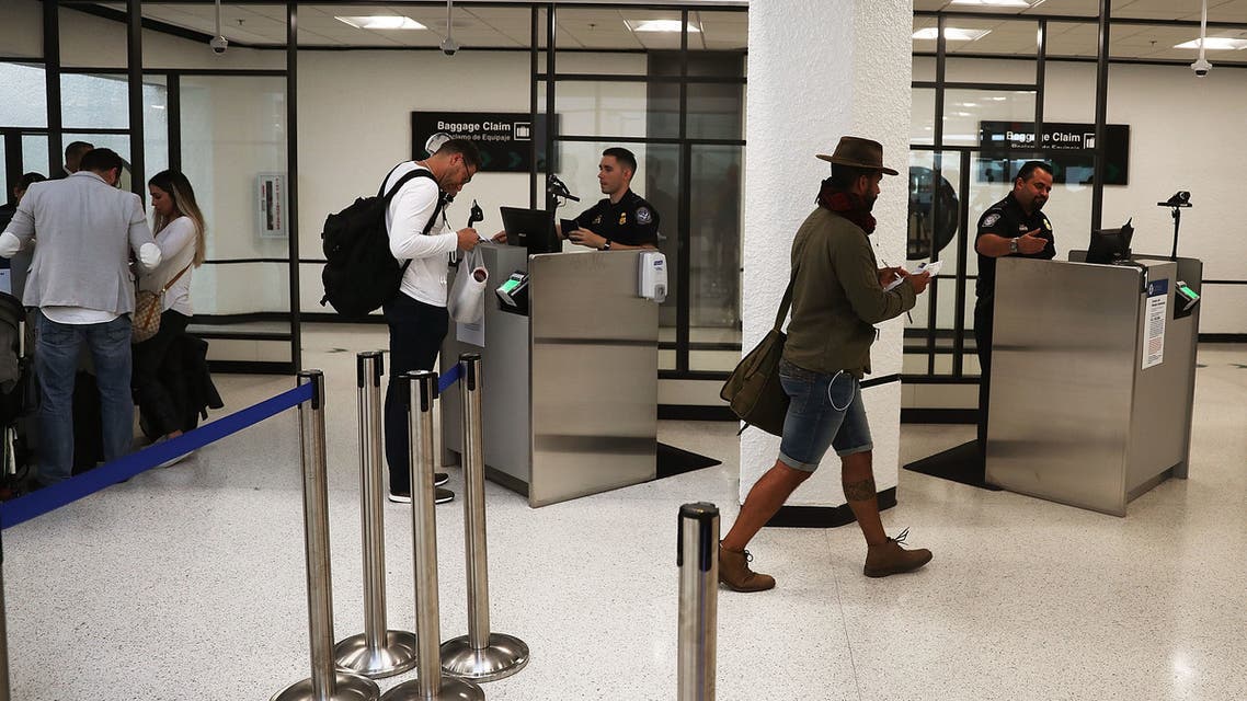MIAMI, FL - FEBRUARY 27: U.S. Customs and Border Protection officers use facial recognition technology in their booths at Miami International Airport to screen travelers entering the United States on February 27, 2018 in Miami, Florida. The facility is the first in the country that is dedicated to providing expedited passport screening via facial recognition technology, which verifies a traveler's identity by matching them to the document they are presenting. Joe Raedle/Getty Images/AFP