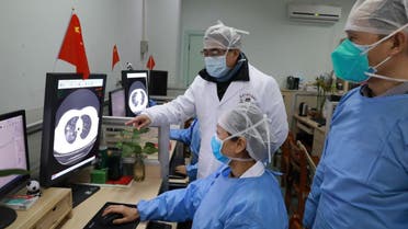Medical workers inspect the CT (computed tomography) scan image of a patient at the Zhongnan Hospital of Wuhan University following an outbreak of the new coronavirus in Wuhan, Hubei province. (Reuters)
