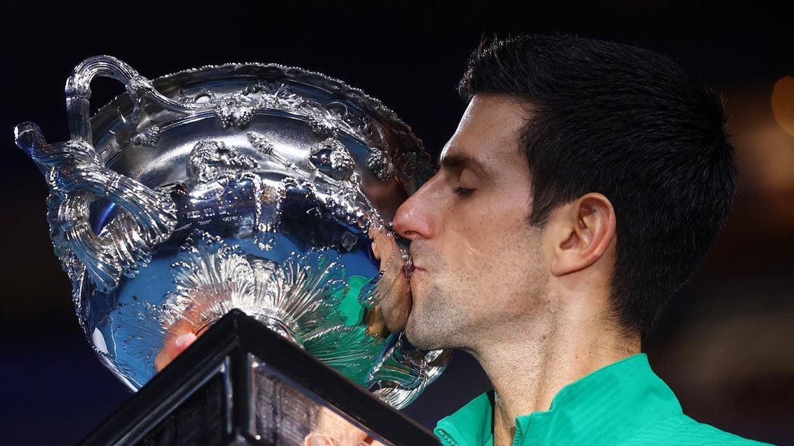 Novak Djokovic kisses the trophy after winning his match. (Reuters)
