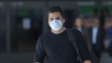 Travelers arrive to LAX Tom Bradley International Terminal wearing medical masks for protection against the novel coronavirus outbreak. (AFP)