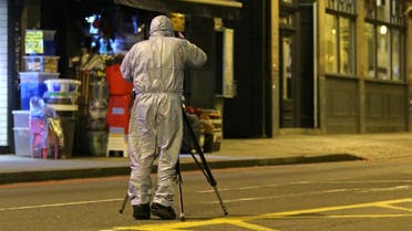 A police forensic officer works on Streatham High Road in south London on February 2, 2020, after a man is shot dead by police following reports of people being stabbed in the street. (AFP)