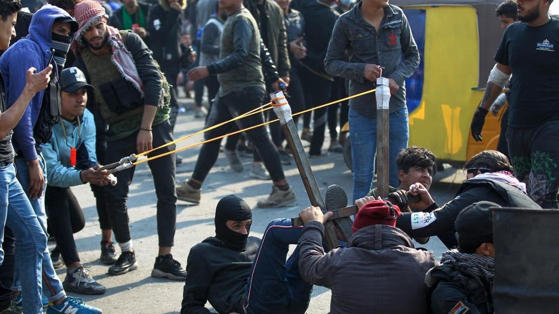 Iraqi protesters use a slingshot to hurl rocks during clashes with security forces following a demonstration at Al Wathba square in the capital Baghdad, on January 30, 2020. (Photo: AFP)
