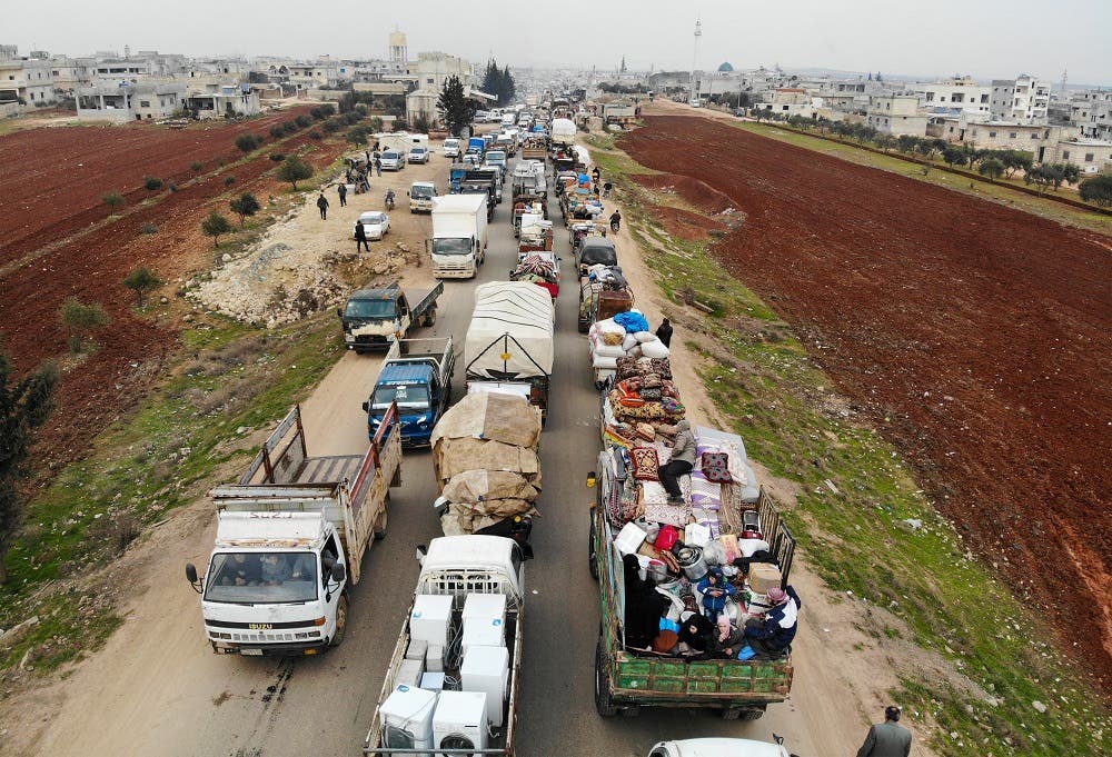 displaced Syrians driving through Hazano in the northern countryside of Idlib, after fleeing on January 28, 2020 its southern countryside towards areas further north near the border with Turkey. afp