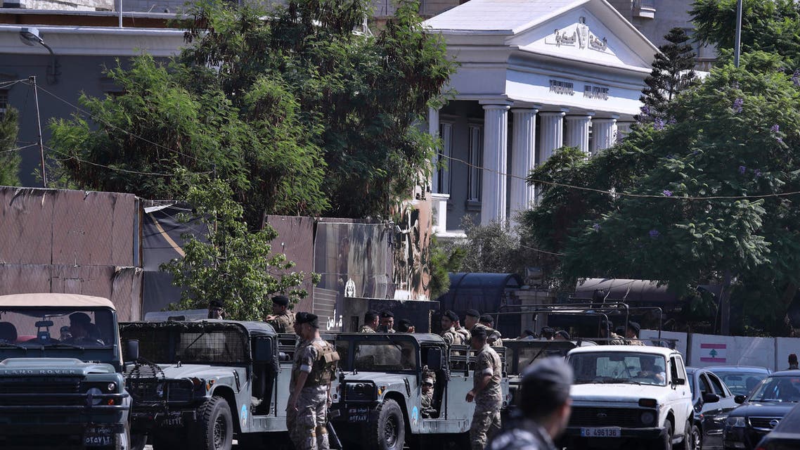 Lebanese Army soldiers stand guard outside a military court where an arrest warrant was issued for Lebanese-American Amer Fakhoury, who confessed he'd worked for Israel during its occupation of Lebanon for nearly two decades, in Beirut, Lebanon, Tuesday, Sept. 17, 2019. Fakhoury was detained after returning to his native Lebanon from the United States earlier this month. (AP Photo/Bilal Hussein)