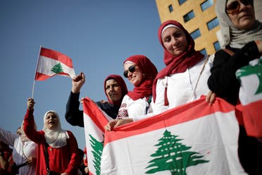 Women carry national flags during ongoing anti-government protests near the Ministry of Education and Higher Education in Beirut, Lebanon November 7, 2019. (File photo: Reuters)