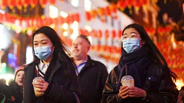 People wearing masks walk in China Town, in London, Saturday, Feb. 1, 2020. (AP)