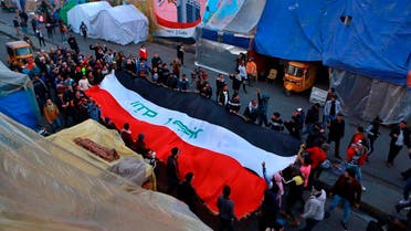 Anti-government protesters chant slogans while holding the national flags during a demonstration against the newly-appointed Prime Minister Mohammed Allawi in Tahrir Square, Baghdad, Iraq, Monday, Feb. 3, 2020. (Photo: Reuters)