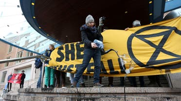 Activists block the entrance to oil giant Shell's headquarters, saying the company's plans to continue investment in developing new sources of gas and oil show the company is not taking the threat of climate change seriously in The Hague, Netherlands. (Reuters)