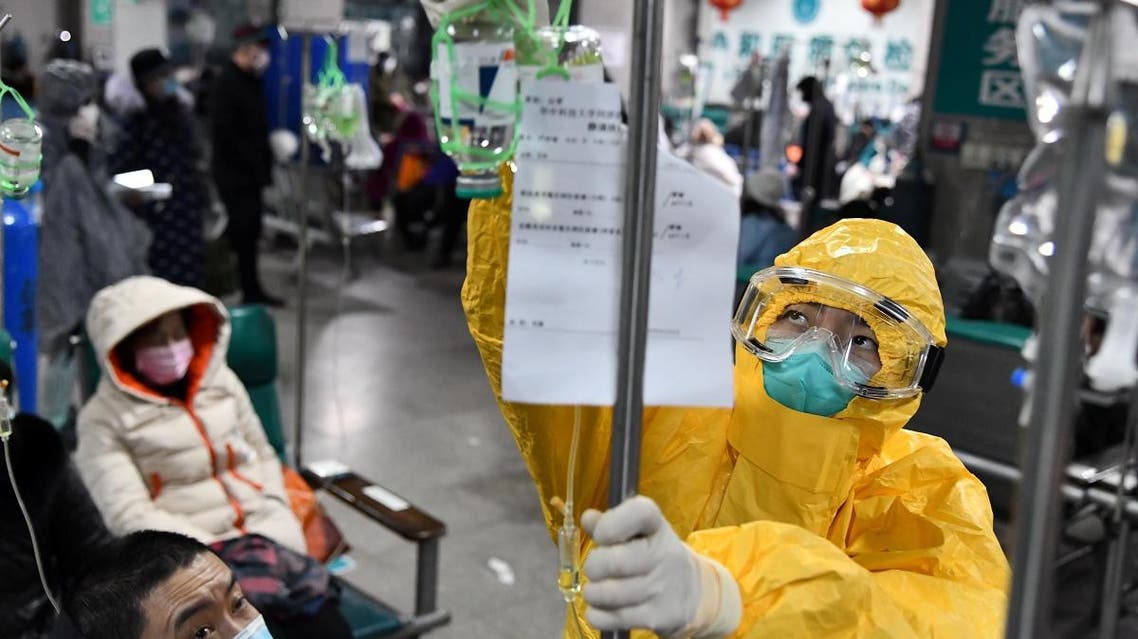 A medical worker in protective suit adjusts a drip bag for a patient at a hospital, following an outbreak of the new coronavirus in Wuhan, Hubei province, China February 3, 2020. (Photo: Reuters)