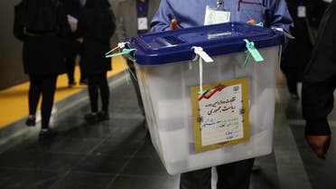 An electoral worker carries a ballot box after closing vote in a polling station in Tehran, Iran, May 19, 2017. (Reuters)