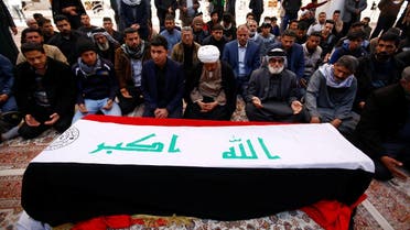 Mourners pray near a coffin of a demonstrator who was killed at an anti-government protest overnight in Nassiriya, during a funeral in Najaf. (Reuters)