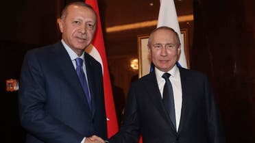 Russian President Vladimir Putin, right, shakes hands with Turkish President Recep Tayyip Erdogan on the sideline of the conference on Libya. (AP)