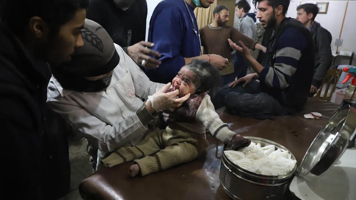 A Syrian infant receives treatment as victims of reported regime air strikes on Hamouria, Saqba and Kafr Batna are brought to a make-shift hospital in the rebel-held enclave of Eastern Ghouta on March 7, 2018. (AFP)