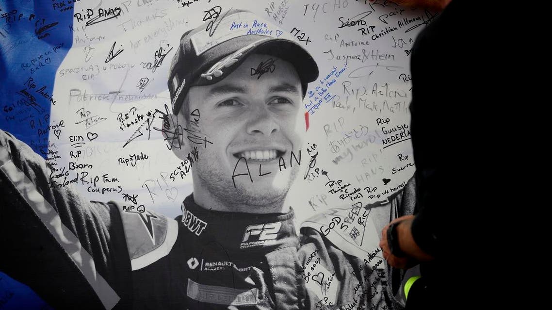 A man signs a remembrance board for Formula 2 driver Anthoine Hubert at the Belgian Formula One Grand Prix circuit in Spa-Francorchamps, Belgium. (AP)